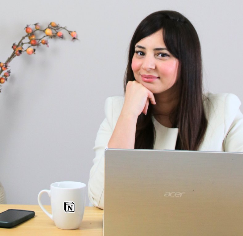 Rim at her desk with a laptop and a Notion mug